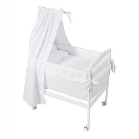 diagrama mostrando las partes de una minicuna con dosel: estructura (tijeras/cuadrada), colchón, vestidura de minicuna, dosel, vestidura de dosel.