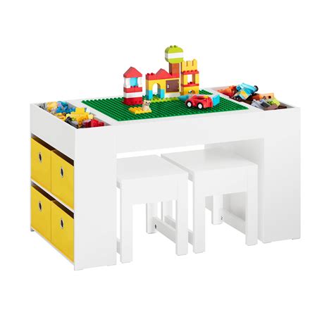 Infografía detallada mostrando la mesa infantil Sobuy con su tablero giratorio: un lado para piezas de Lego Duplo y el otro con una superficie lisa para dibujar y comer.