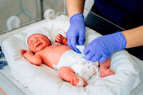 Foto de padres interactuando con su bebé prematuro en una UCIN