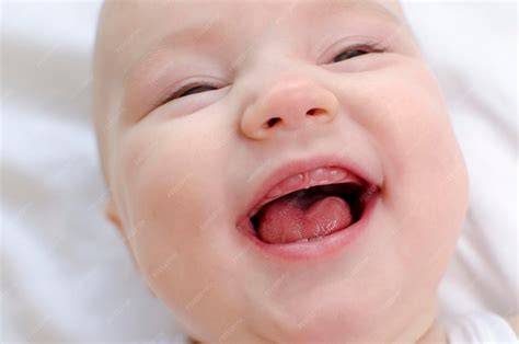 Bebé con la boca abierta mostrando su lengua