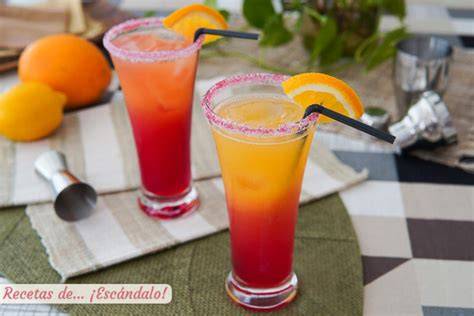 Cóctel de granadina y naranja sin alcohol con frutas ensartadas