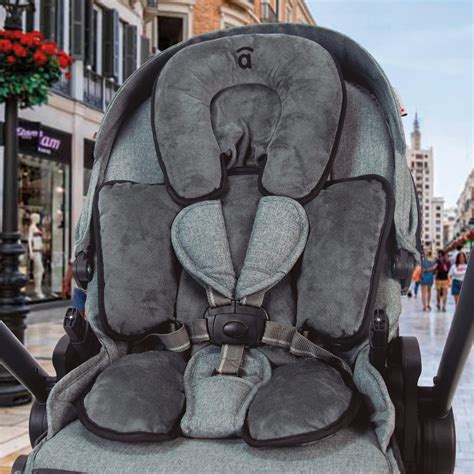 Bebé cómodo en una silla de paseo con reductor