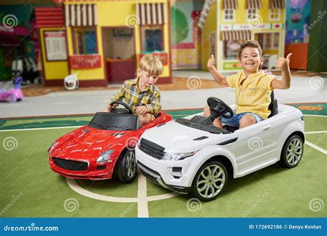 Foto de niños conduciendo coches eléctricos infantiles en un parque