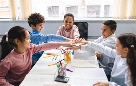 Niños colaborando en el montaje de un circuito Scalextric, mostrando trabajo en equipo