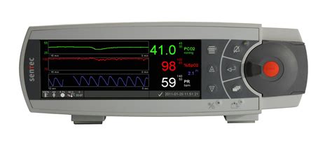 Foto de un monitor transcutáneo de CO2 con el sensor colocado en la piel de un neonato, mostrando su pequeño tamaño.