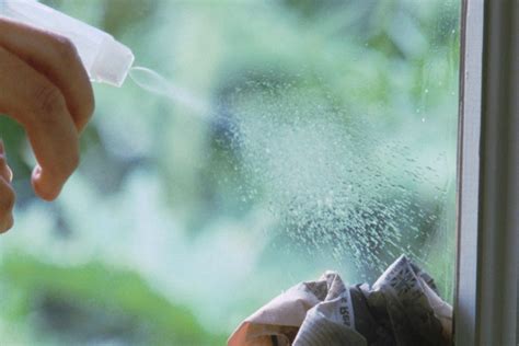 Primer plano de una tarjeta de plástico retirando suavemente una pegatina de un cristal.
