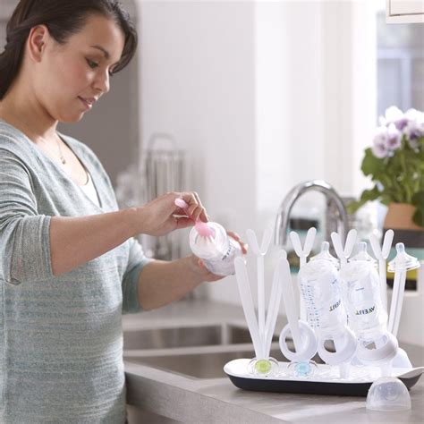 Ilustración mostrando el lavado y esterilización de biberones y tetinas