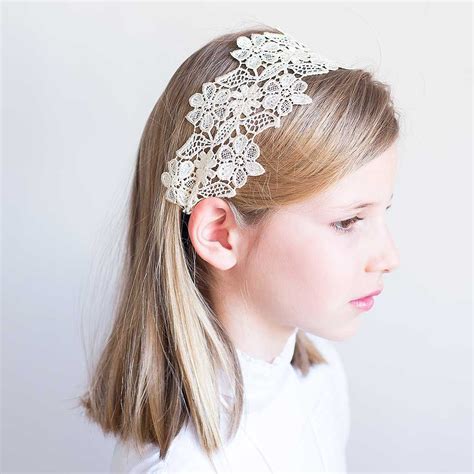 Mesa con diferentes diademas de comunión, con encajes y flores blancas