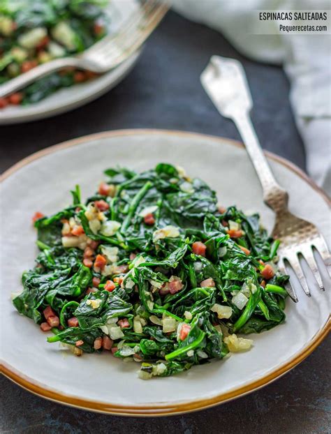 Foto de espinacas salteadas con queso feta, pipas y pasas en un plato