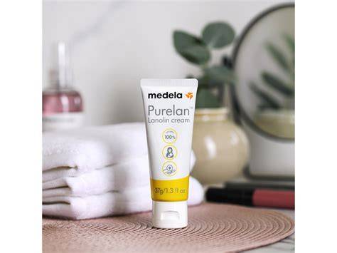 Tubo de crema Medela PureLan 100 y una hoja de parra como símbolo de naturalidad