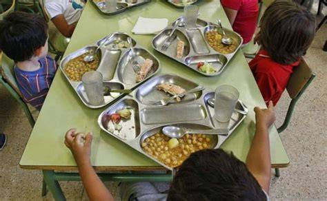 Foto de niños jugando en un comedor escolar con comida casera