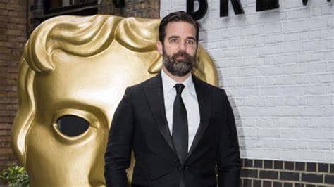 Fotografía emotiva del actor Rob Delaney o imagen simbólica de la lucha contra el cáncer infantil
