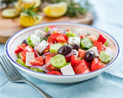 Plato de queso feta tradicional desmenuzado sobre una ensalada griega