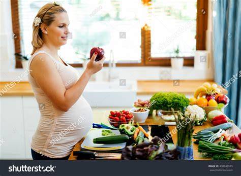 Thematic photo of a pregnant woman eating a healthy meal with fruits and vegetables