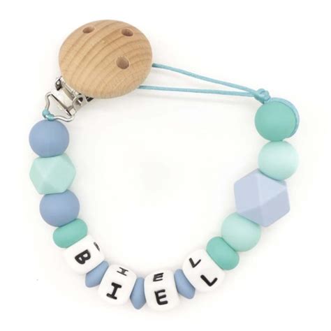 Ilustración mostrando las diferentes partes de un chupetero personalizado con opciones de colores y cuentas.